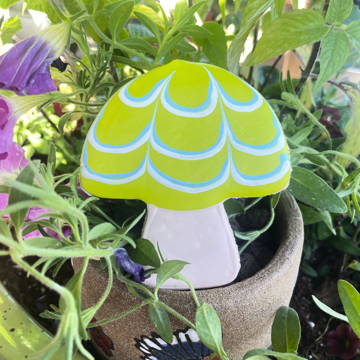 Mushroom-shaped dog cookie with lime green and blue icing from Lucky Biscuit Pet Bakery