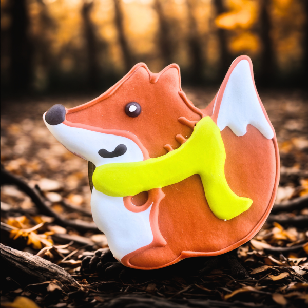 Fox-shaped dog cookie with yellow scarf from Lucky Biscuit Pet Bakery